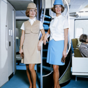 Pan Am flight attendants in new uniforms by spiral staircase of Boeing 747 jet